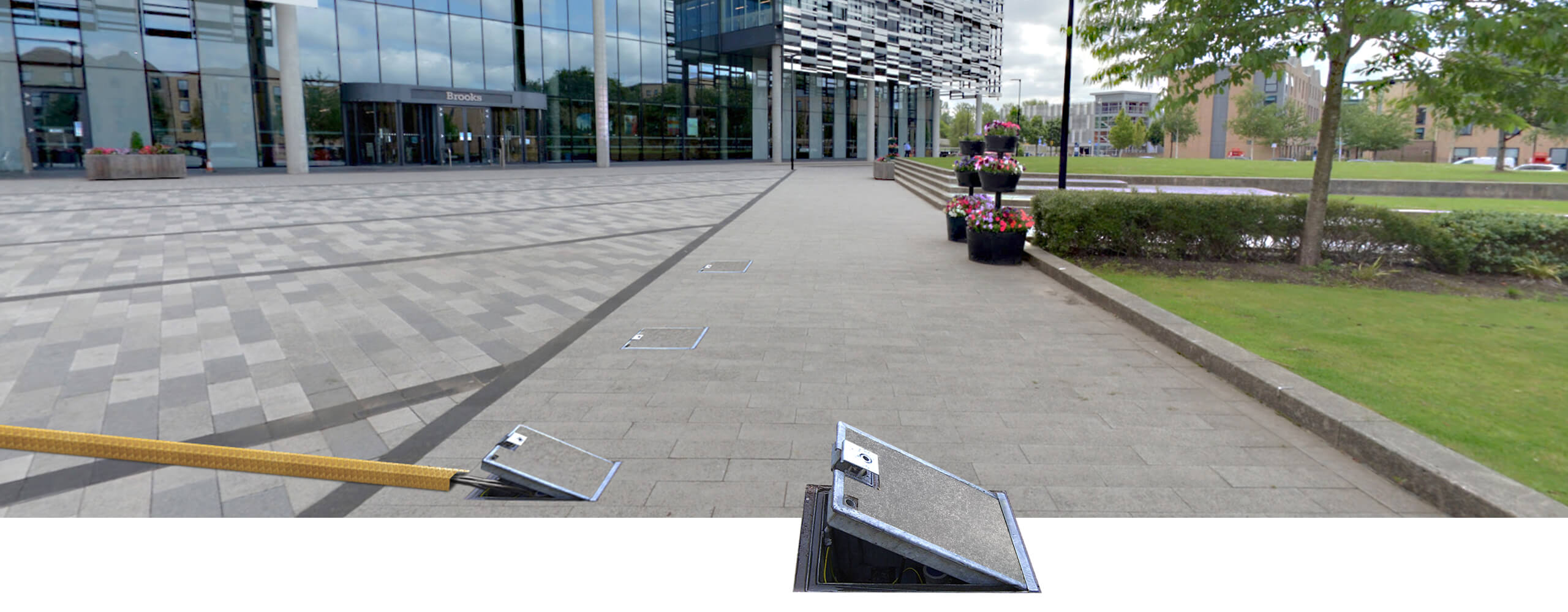 Pop Up Power Supplies in-ground units outside a university campus building
