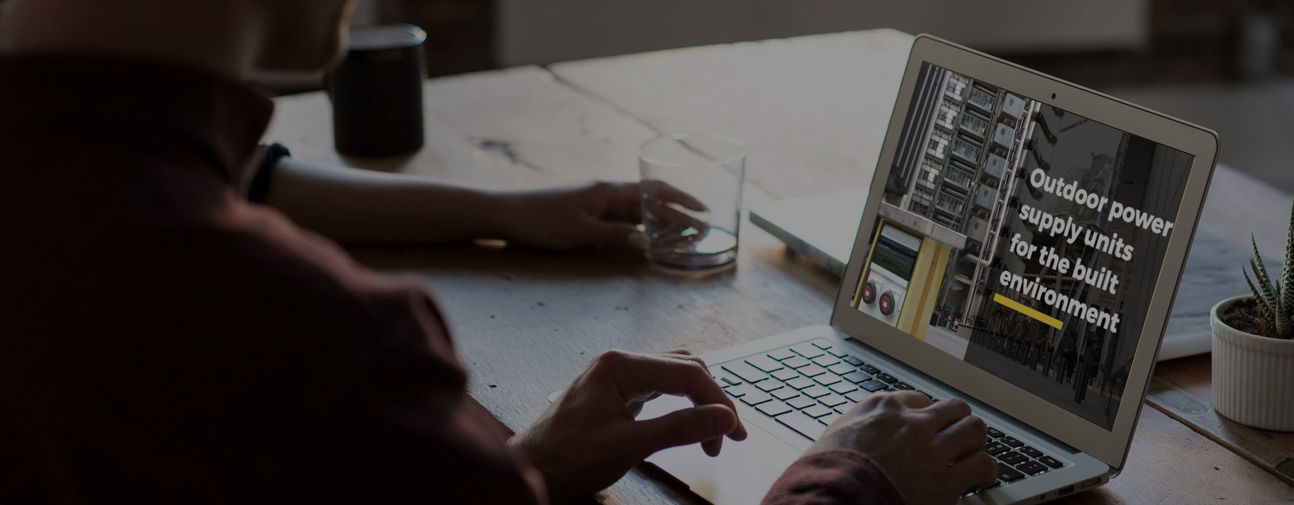 Image of a person viewing a laptop that shows the Pop Up Power Supplies Ltd website