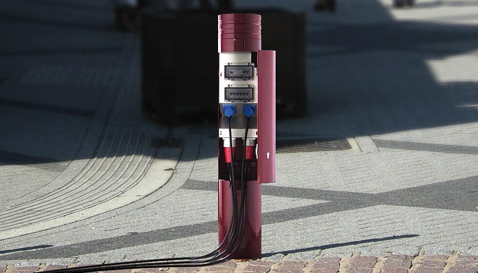 A close up of the Parc Paris shaped power bollard from Pop Up Power Supplies with the door open to show how connections to power can be configured.