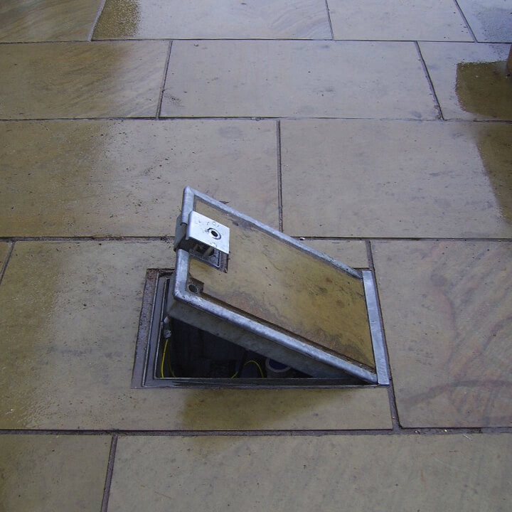 Image of an in-ground unt with the hinged lid open